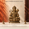Bajrang dhoop beside a Hanuman idol, with floral and musky fragrance-note descriptions