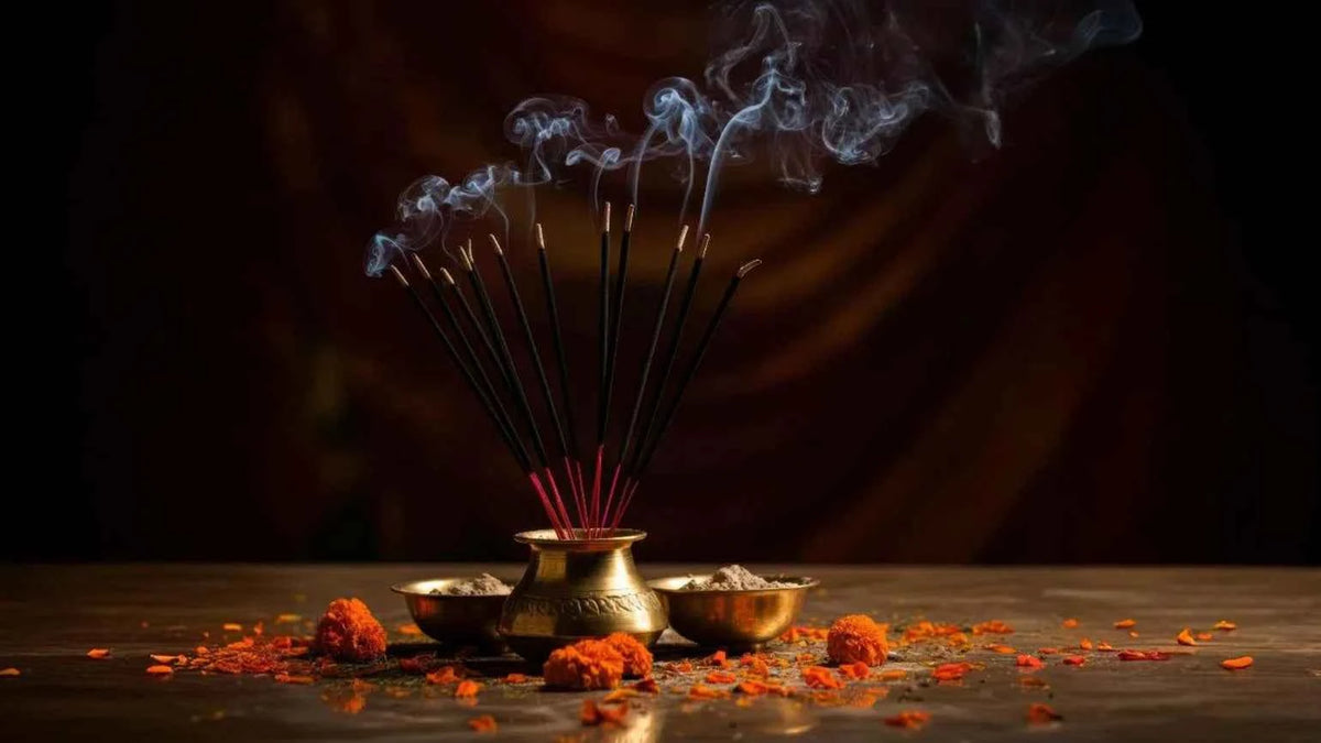 Incense sticks burning with gentle smoke at a home puja altar